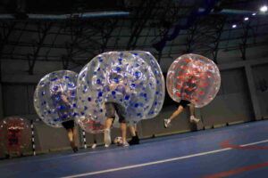 Players in inflatable balls during a bubble football match